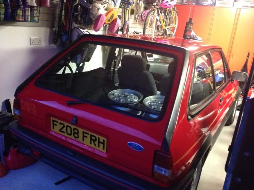 A rear view of the car inside the garage.