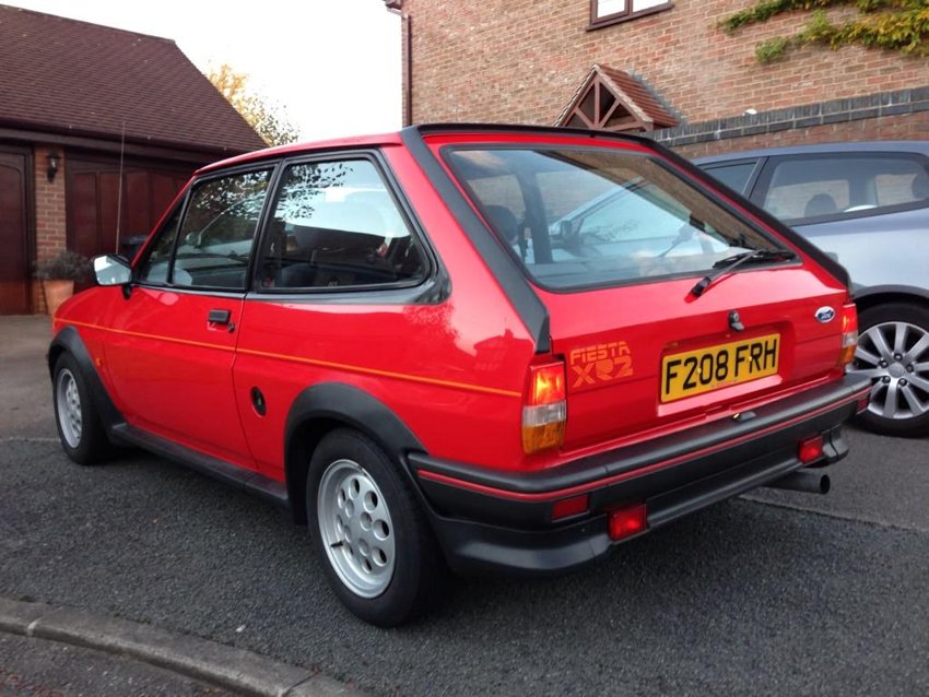 A rear three-quarter view outside the garage.